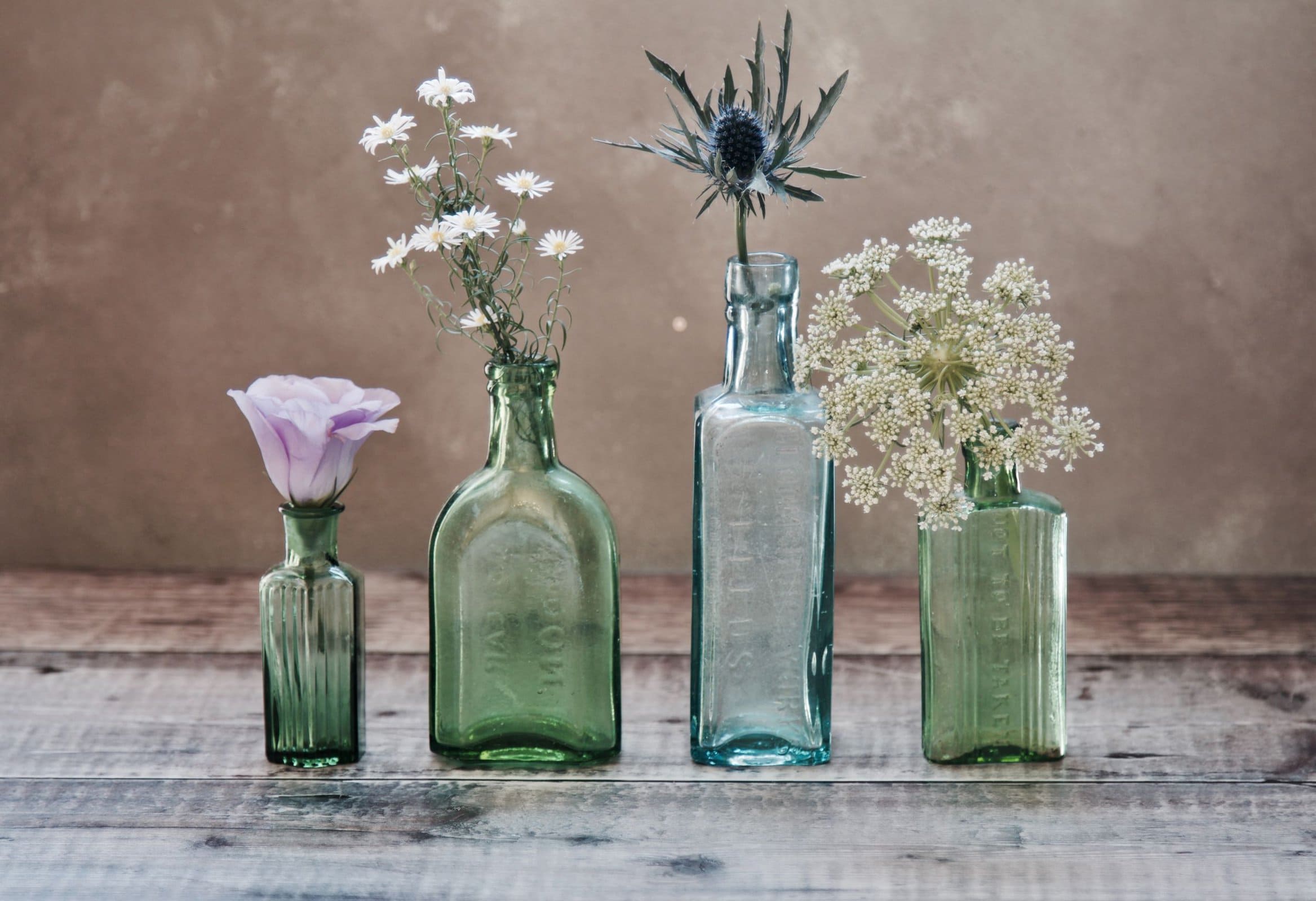 flowers in vintage glass bottles