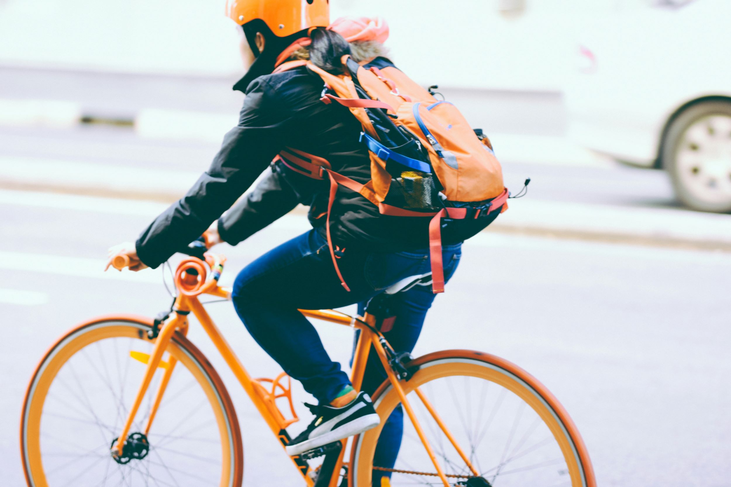 bicyclist wearing bright orange on bright orange bike