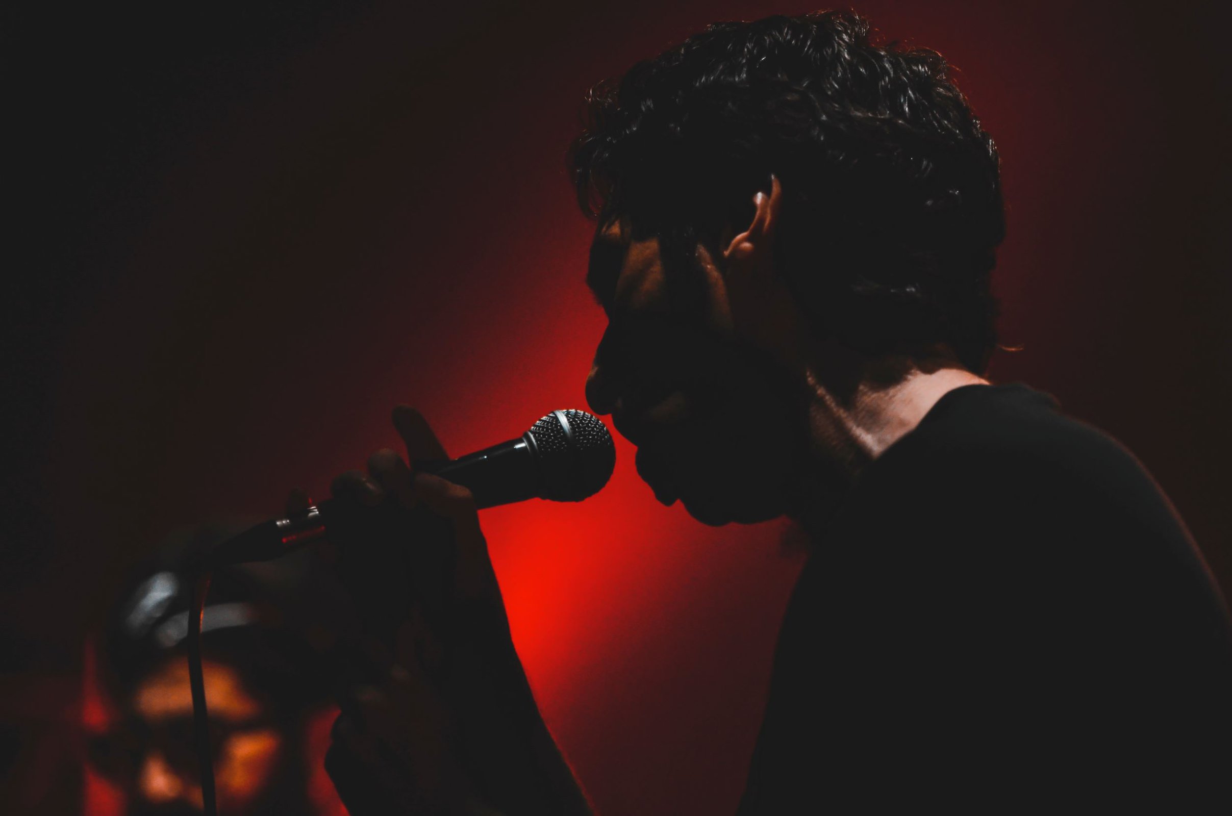 man singing into microphone